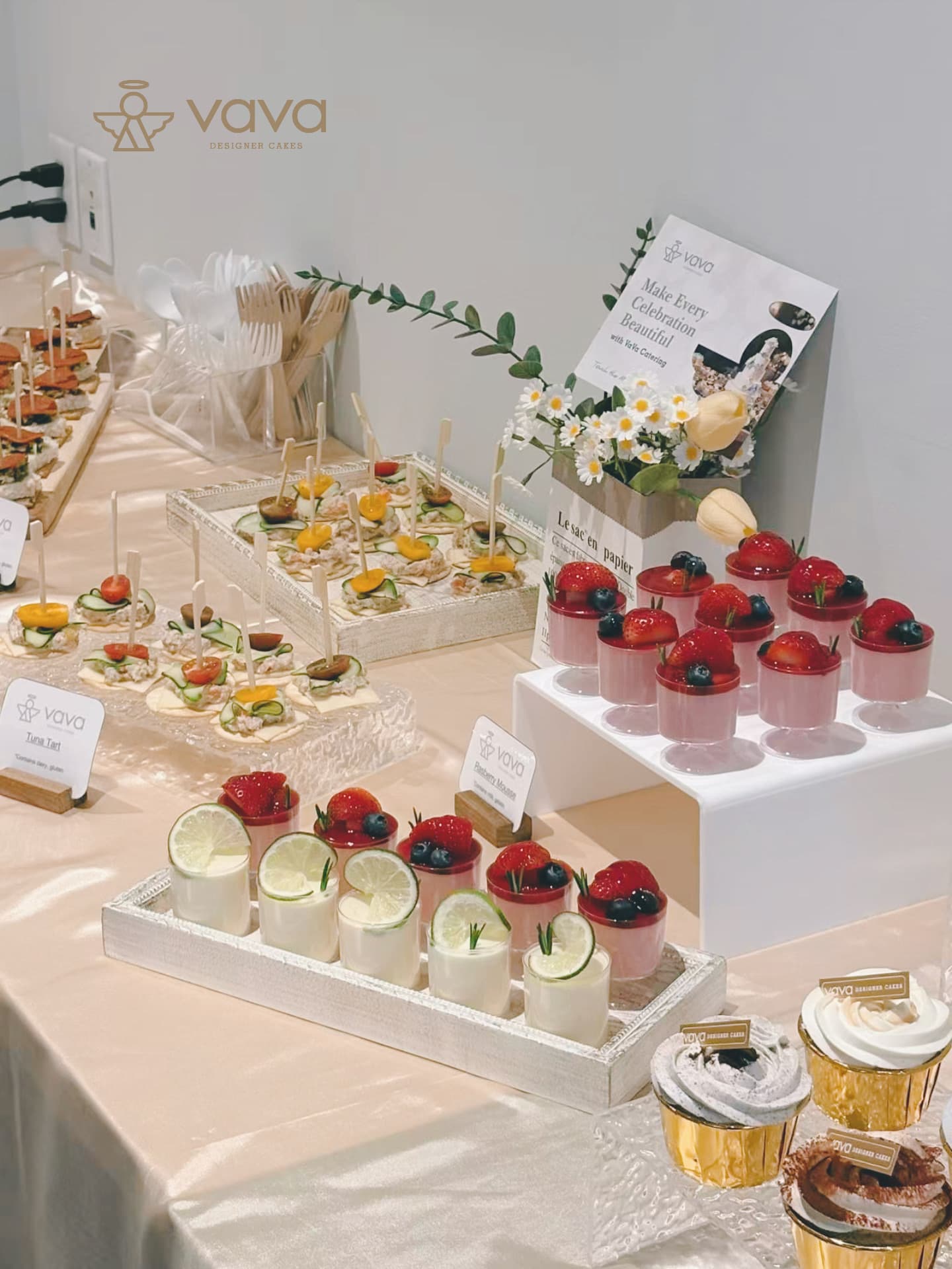 Sweet and savoury table with tuna canapés, strawberry mousse cups and lime dessert shots