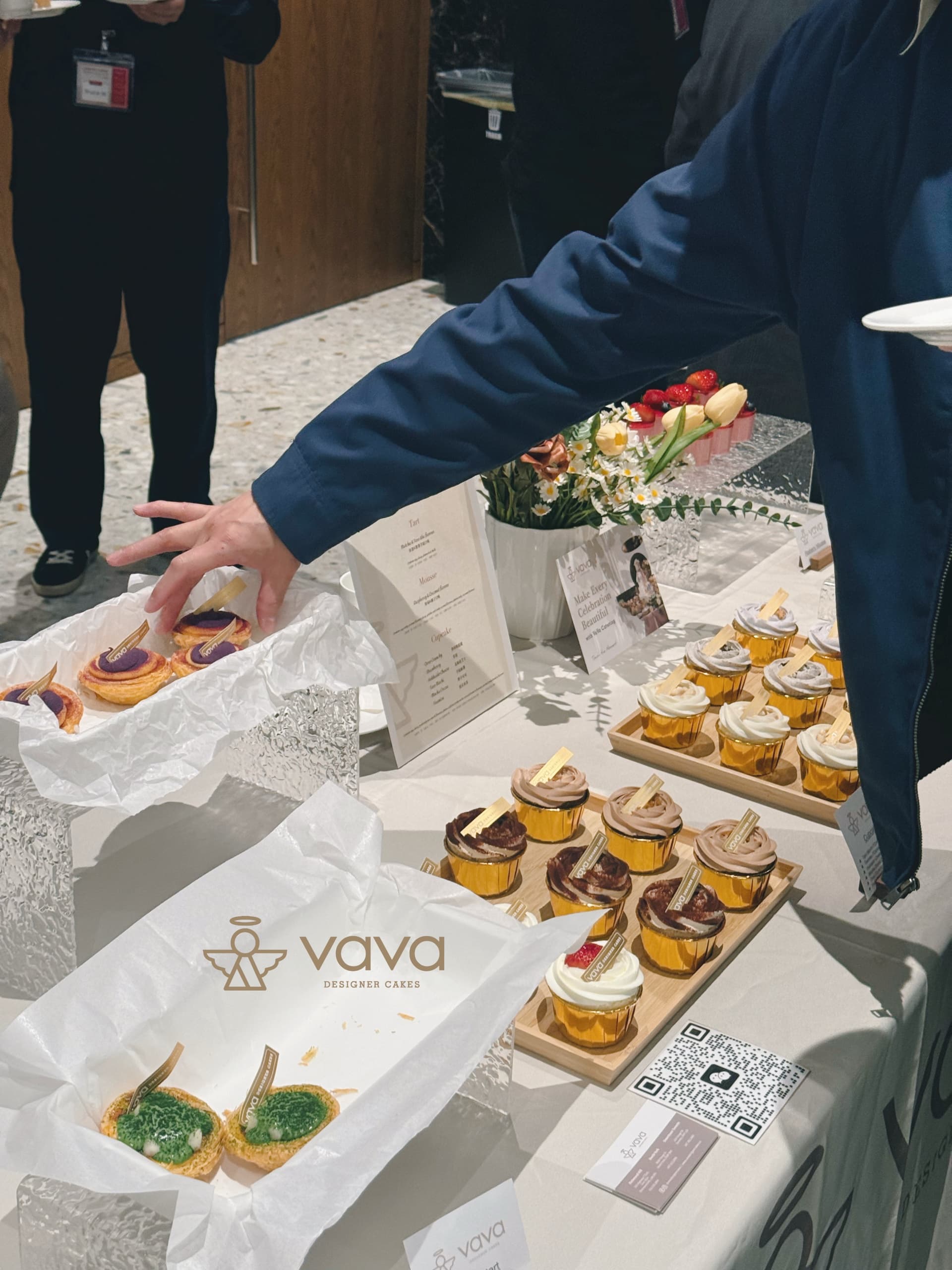 Guest taking a tart from a Vava dessert table at a Toronto corporate event