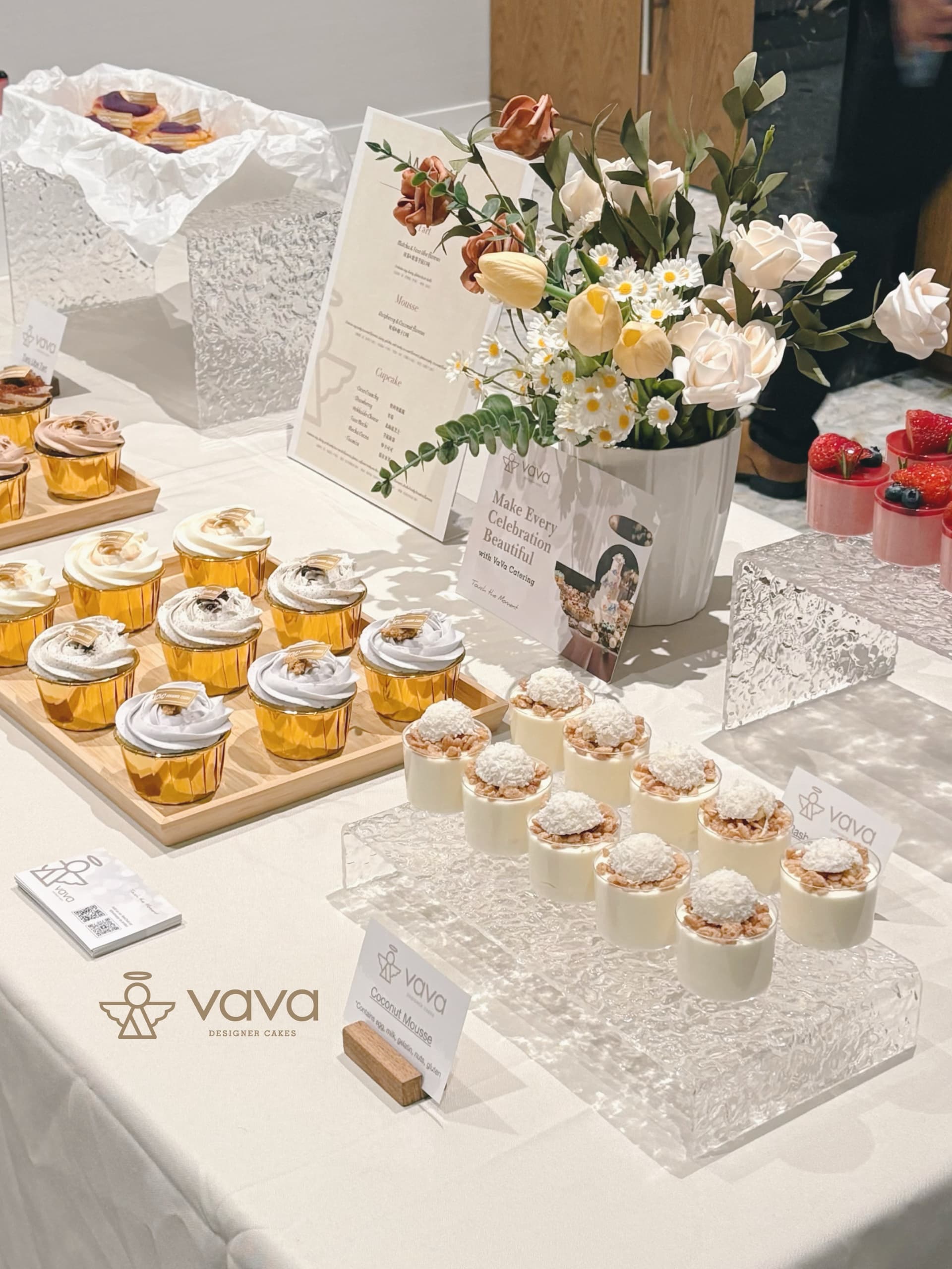 Vava corporate dessert table with cupcakes, coconut mousse cups and menu signage at a Toronto office event